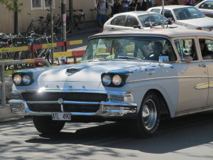 Men drive vintage American cars